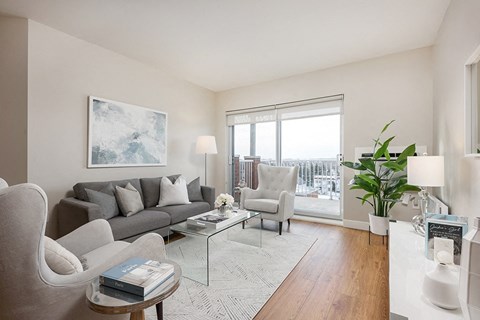 a living room with a couch and a table and a window